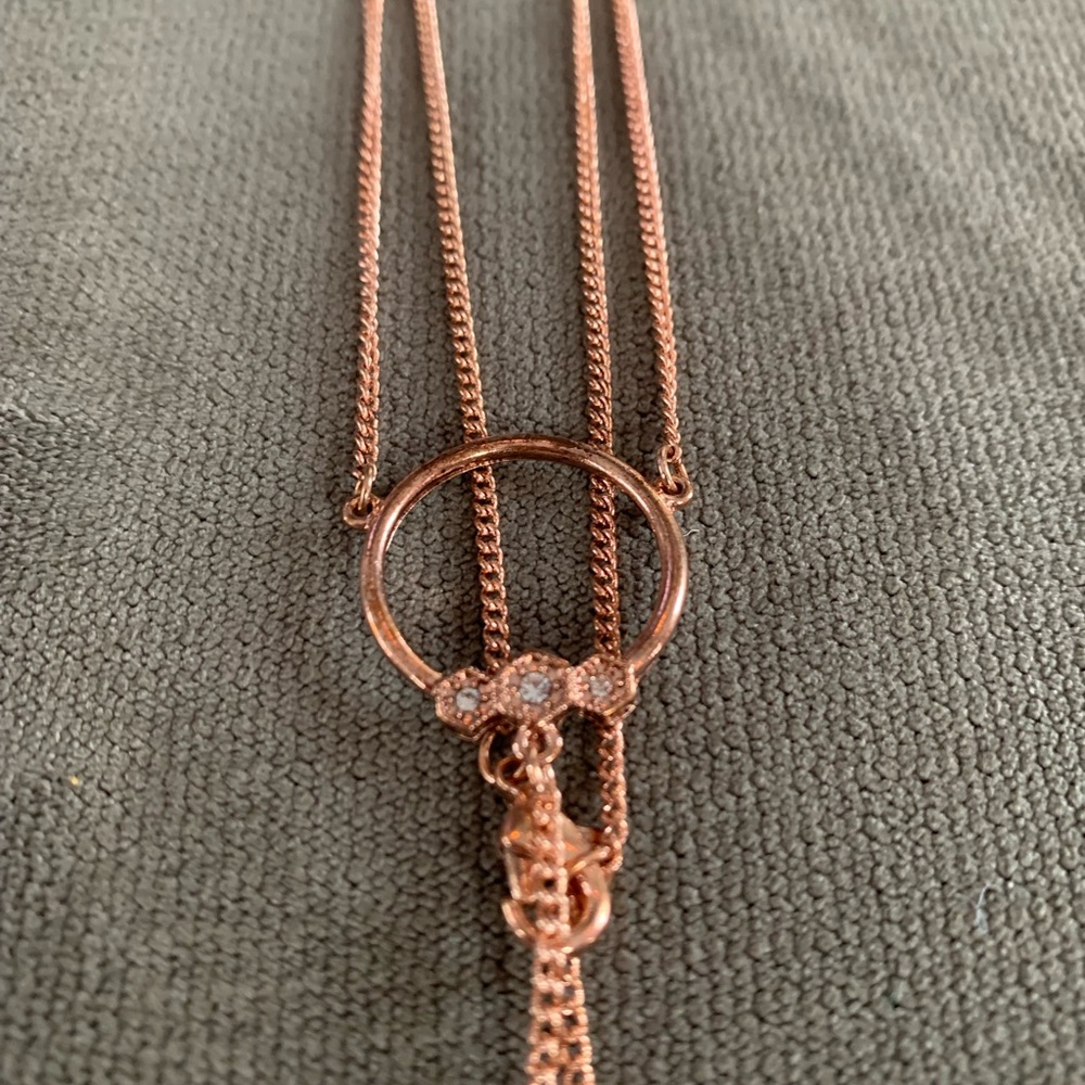LuvAJ lariat necklace. Rose gold tone metal. Rhinestone accents.